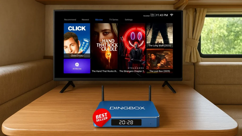 A tv box for RV placed on a table in front of a flat-screen TV inside an RV